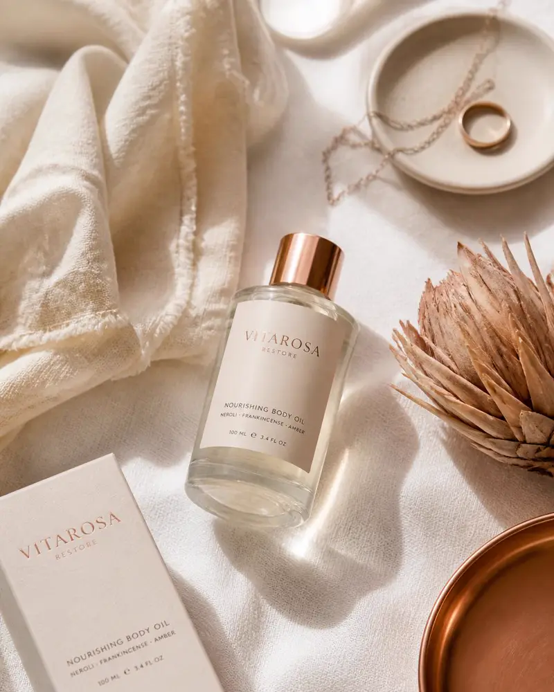 Rose gold self-care essentials arranged on ivory linen in soft morning light